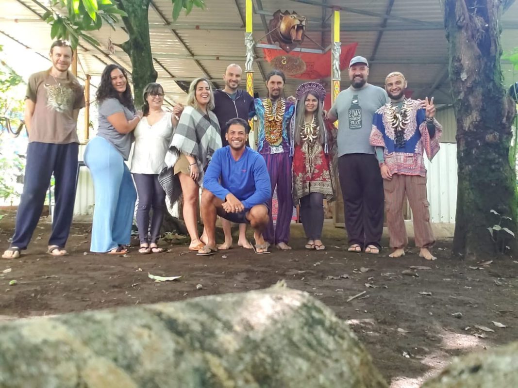 Group of about a dozen people at the site of the ayahuasca ceremony in the jungle
