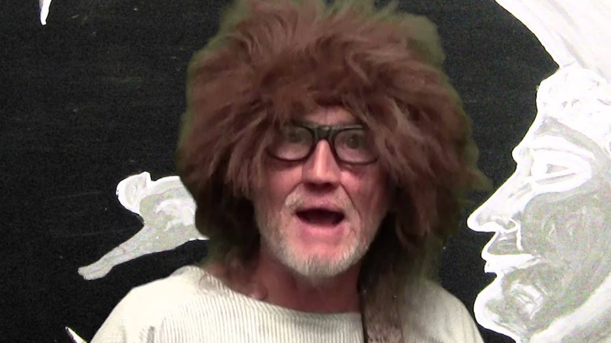Peter Miller in 2021 with white beard, glasses, and large brown wig