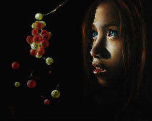 Close-up of woman's face with red and white fruit dangled in front of her