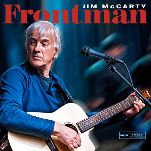 Jim McCarty Frontman Cover with McCarty wearing long-sleeved blue shirt and strumming an acoustic guitar