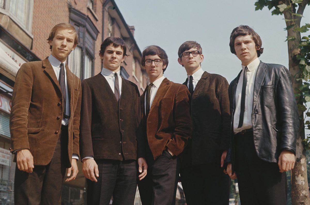 Photo of The Zombies from 1965 wearing jackets and ties while standing on a sidewalk