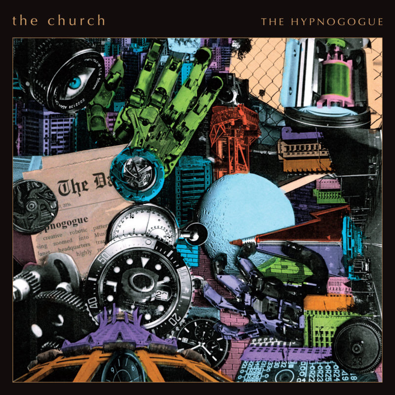 Album cover that looks like a desktop image of clocks, locks, newspaper, and sundry other items cluttered together with band name and album title in black across top