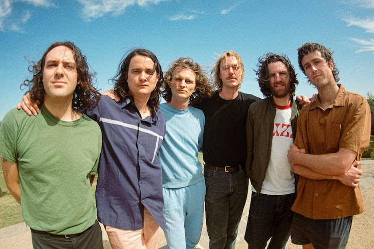 King Gizzard band members posing standing up