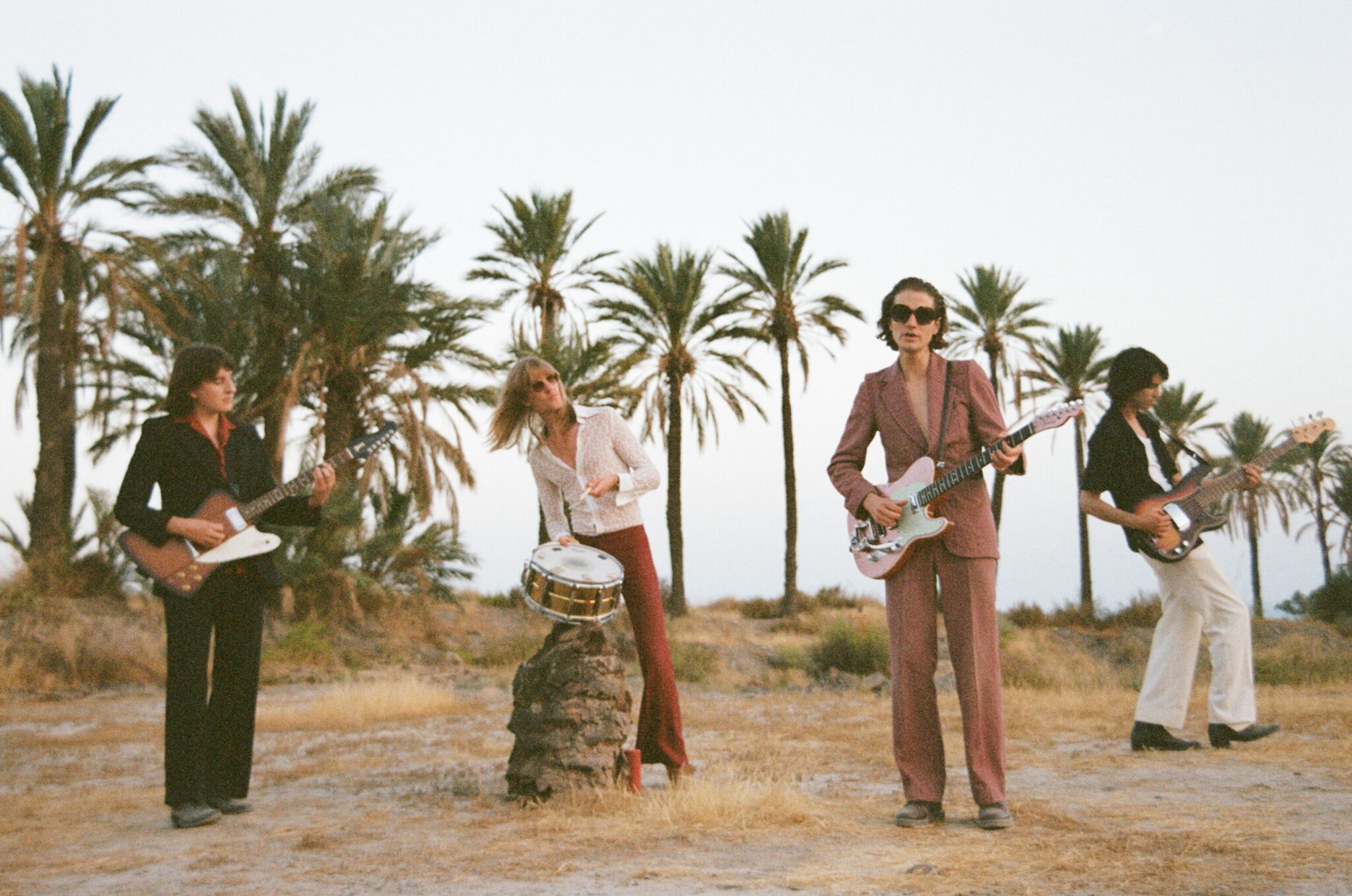 Temples band outside with palm trees in background