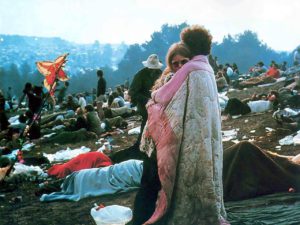 Woodstock picture of couple embracing with blankets