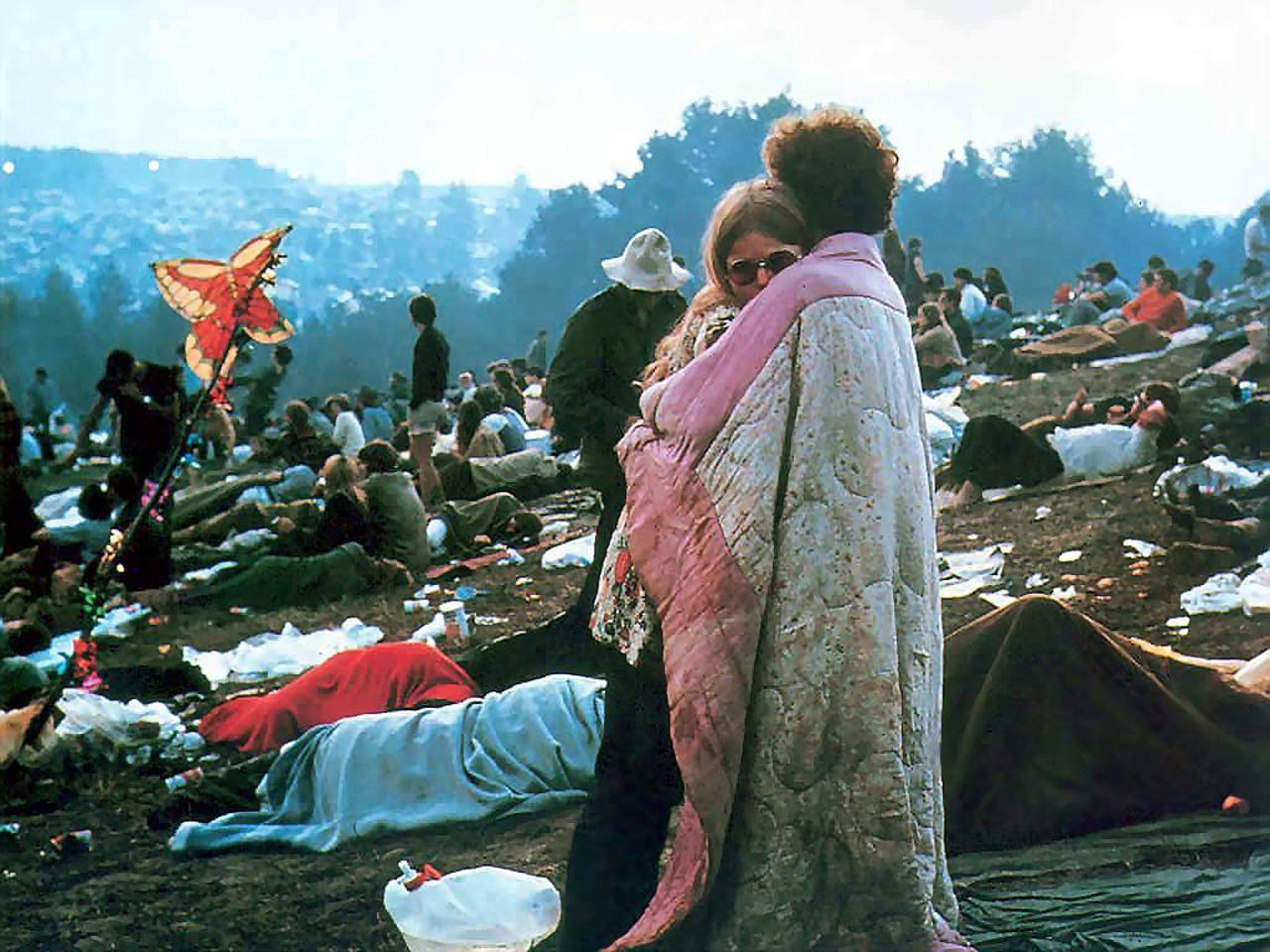 Woodstock picture of couple embracing with blankets
