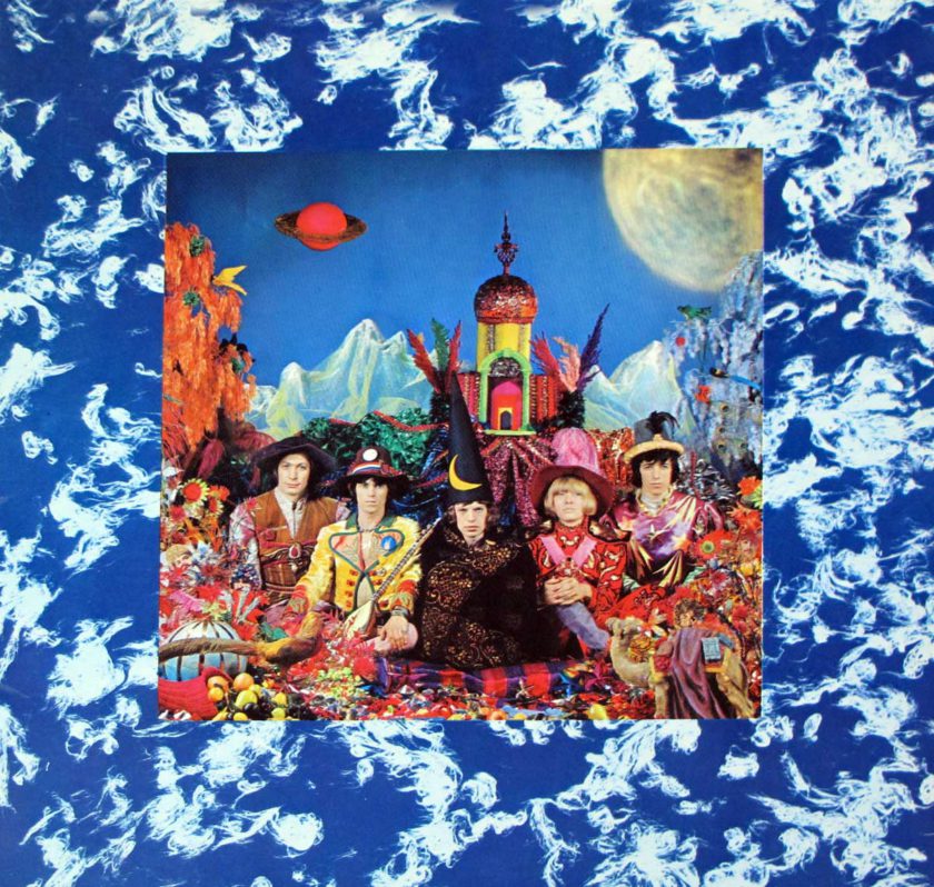 Rolling Stones members wearing wizard robes and hats with psychedelic backgrounds