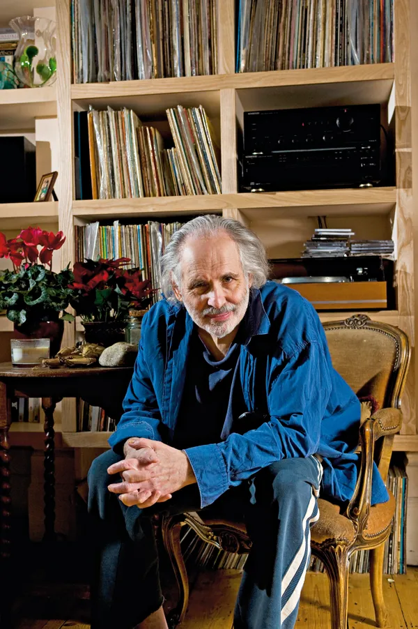 Pete Brown at home with record collection behind him
