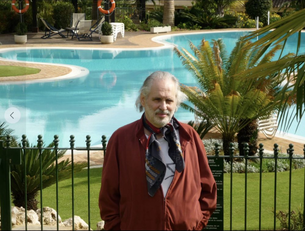 Middle aged Pete Brown standing in front of swimming pool