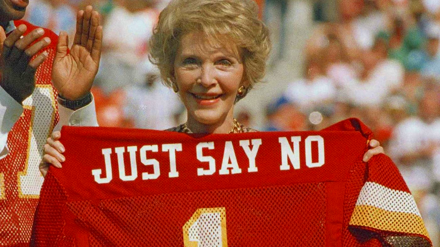 Nancy Reagan holding up jersey that says, "Just Say No"