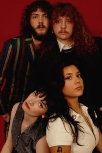 Sunfruits band members posting close together