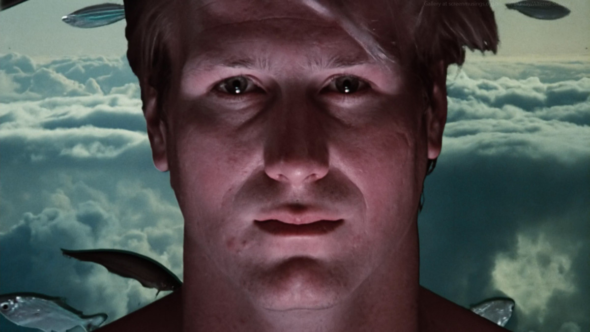 William Hurt's face with blu-ish green clouds behind it