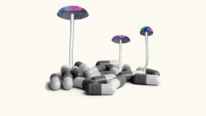 Psilocybe cubensis mushrooms with multi-colored lids appearing to grow out of a field of gel caps