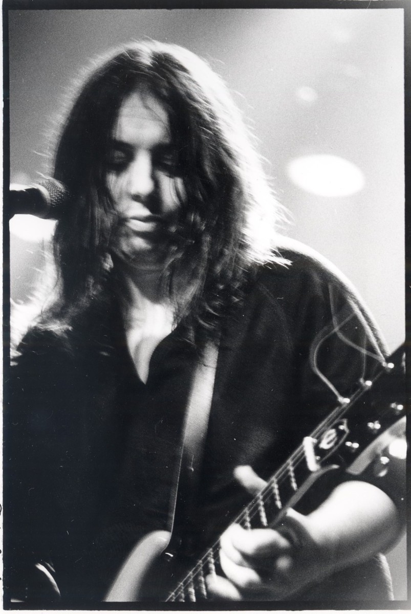 Man with long hair playing guitar