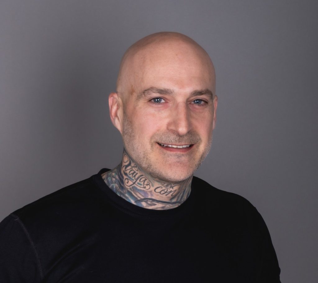 Bald white man with neck tattoos
