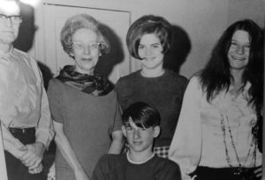 Black and white photo of Janis Joplin with her parents and siblings