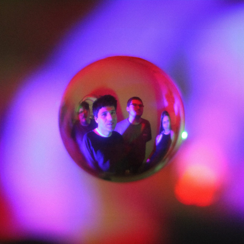 Fish-eye image of four people standing up with a square frame around it