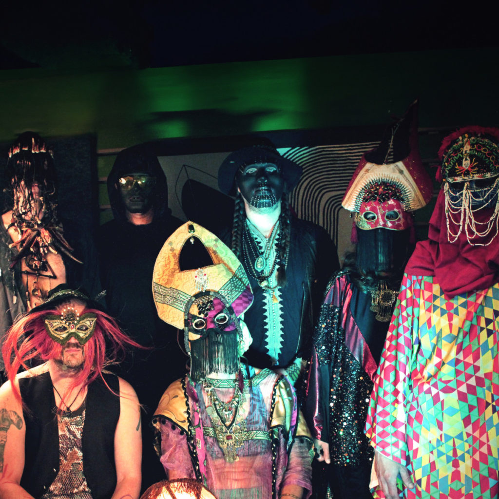 Photo of the members of the band Goat in tribal costumes that disguise their identities with dark background