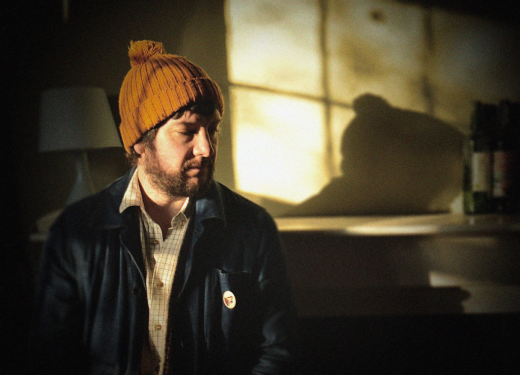 Photo of bearded man in jacket and beanie