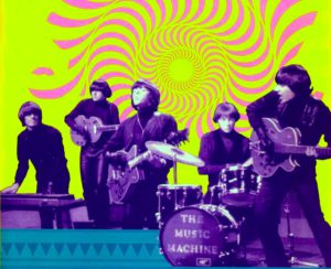 Photo of the band Music Machine performing with photoshopped background that greenish-yellow with a psychedelic sun transposed on it.