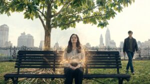 Woman sitting on a park bench enveloped in electric current in New York City while man walks up from behind